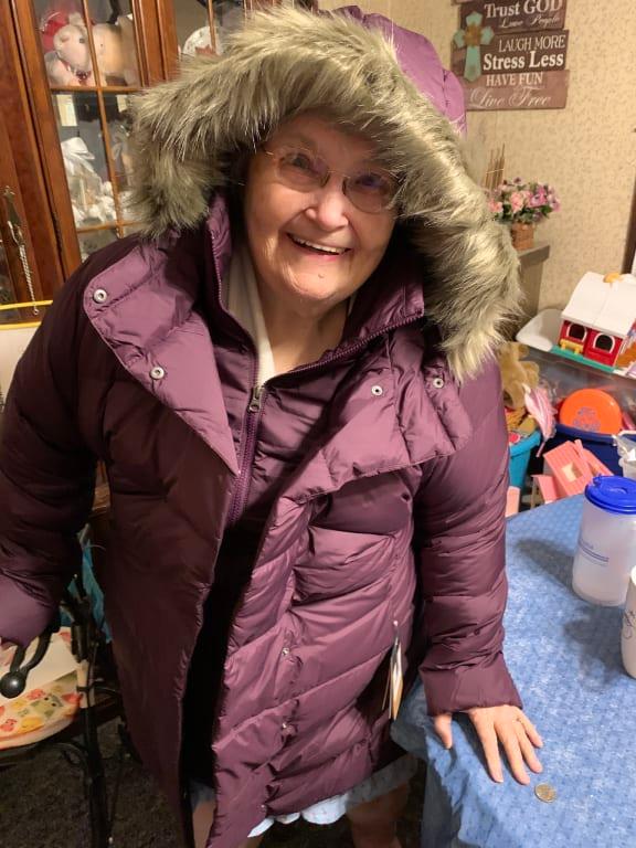 Hoods pulled back about 8 inches to see her face