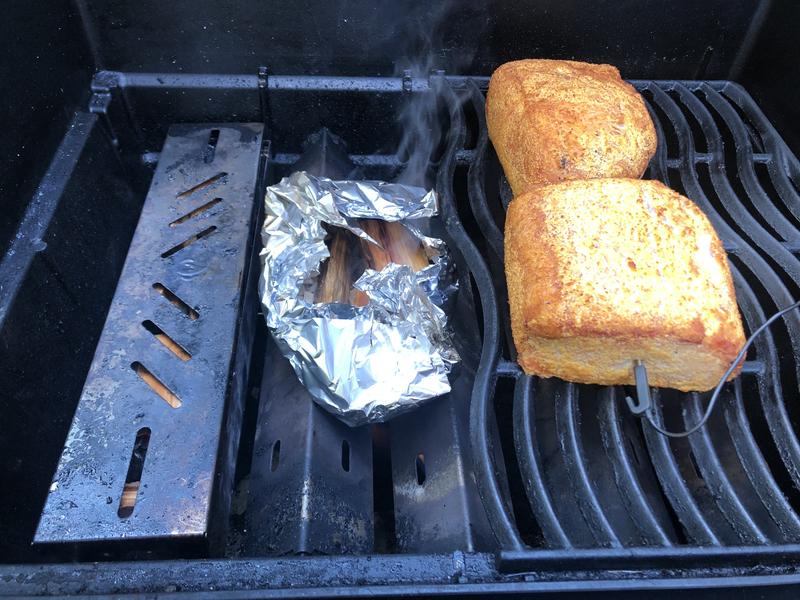 Smoking peameal with cherry wood.  Tin folil packette t add a little more smoke and moisture.