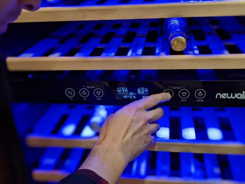 The setting buttons on the left are for the top section of the wine fridge and the buttons on the right are for the bottom section. The top section can be set between 40-50 degrees F and the bottom section can be set between 50-66 degrees F.