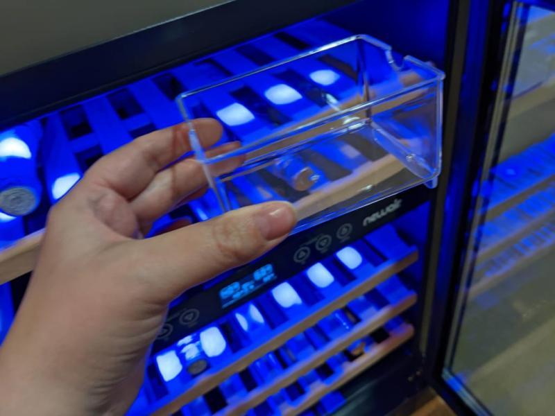 The clearc cup can be half filled with distilled water and placed anywhere in the fridge to add humidity inside which is good for the wine corks.