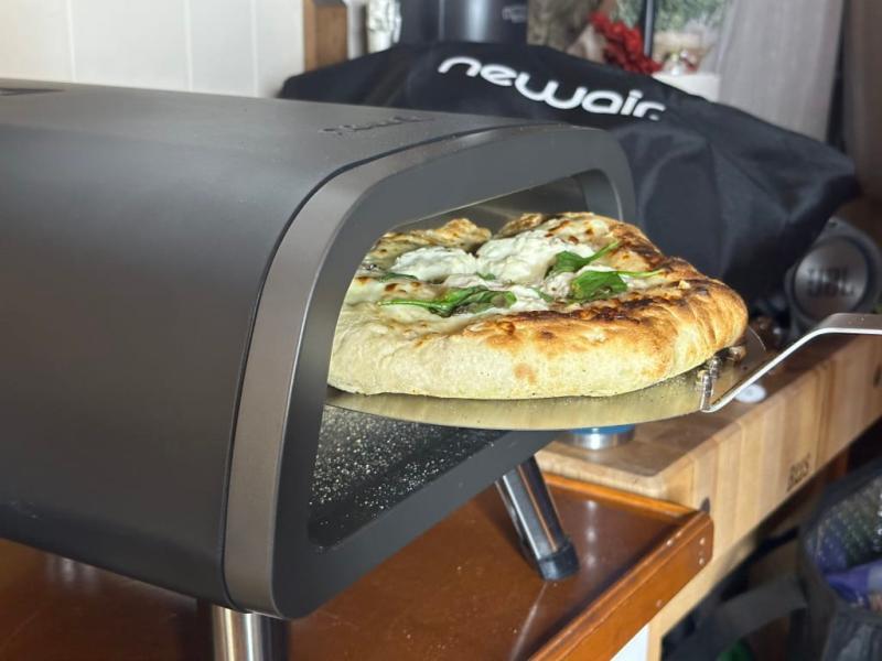 My husband taking the white pizza out of the oven!
