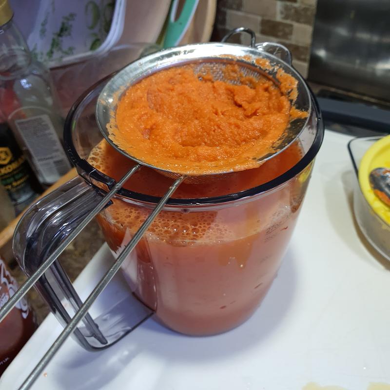 straining with handheld strainer