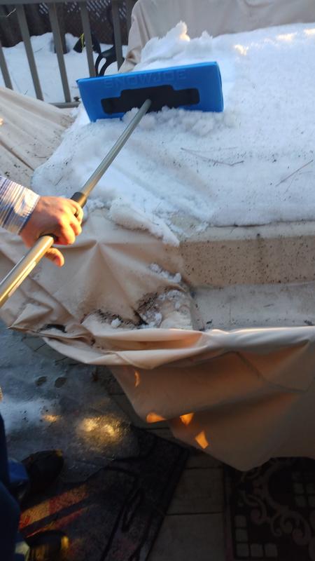 Cleaning snow off outdoor table.