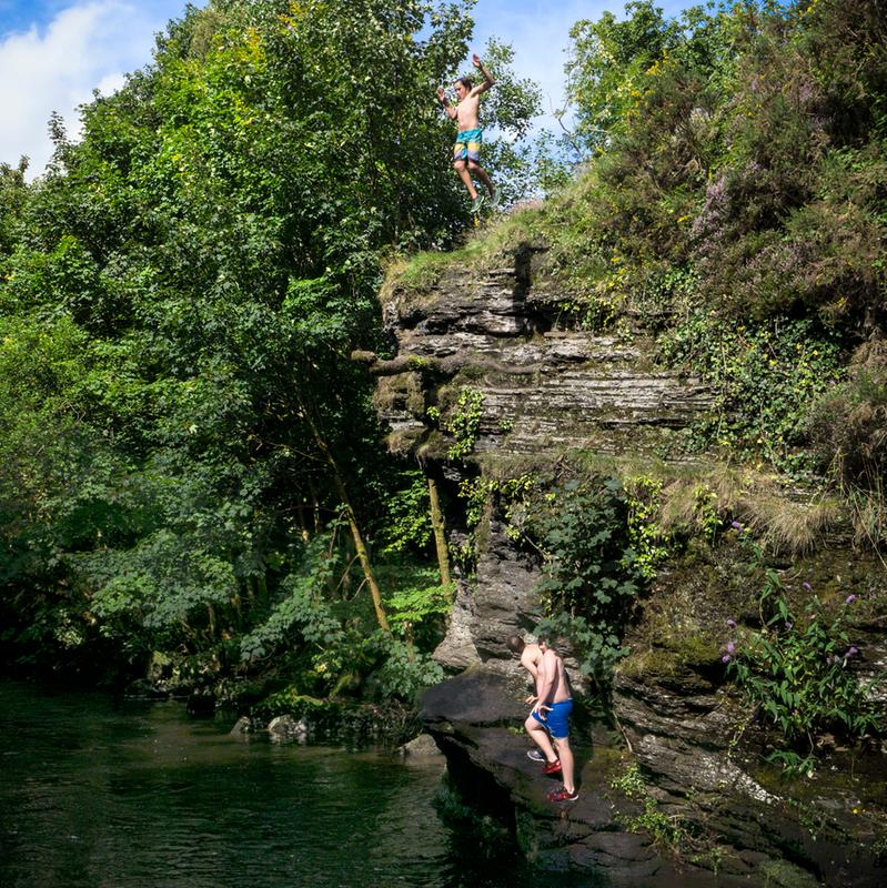 Children jumping into the river on a summer's day...