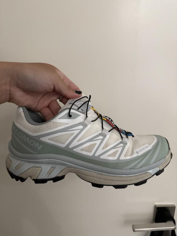 White in one area but no longer white, more of a grey, for the rest of the shoe