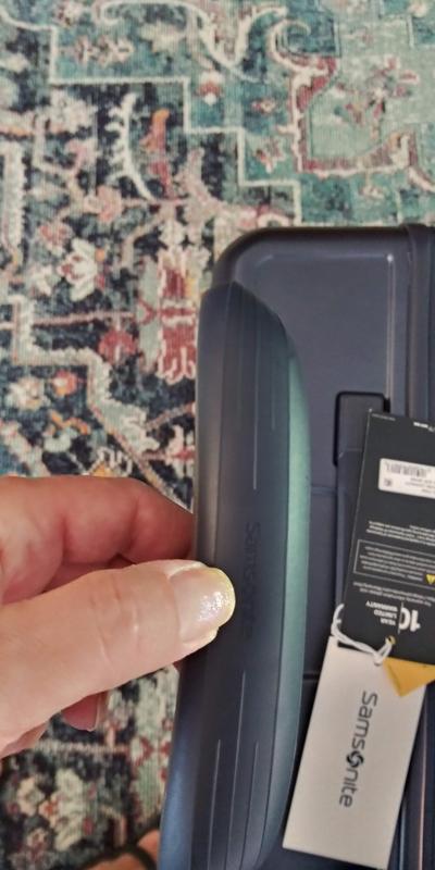 button in the middle under Samsonite logo to raise and lower the handle