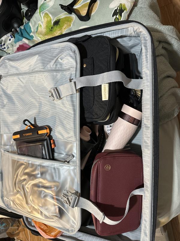 A partially packed carryon suitcase.