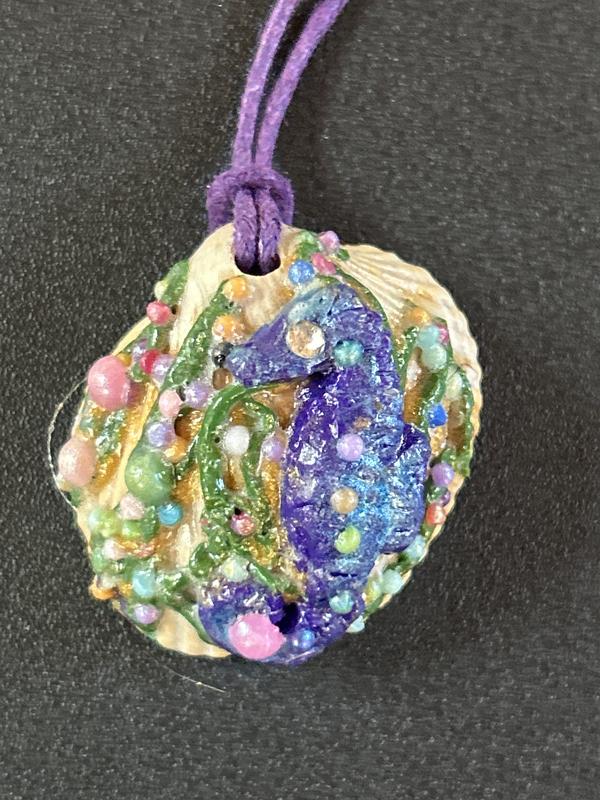 Purple sea horse on sea shell with original sculpey and liquid sculpture.