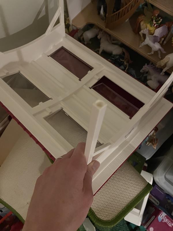 Hole on bottom of removable roof leg that fits on the peg on the stable to hold it in place.