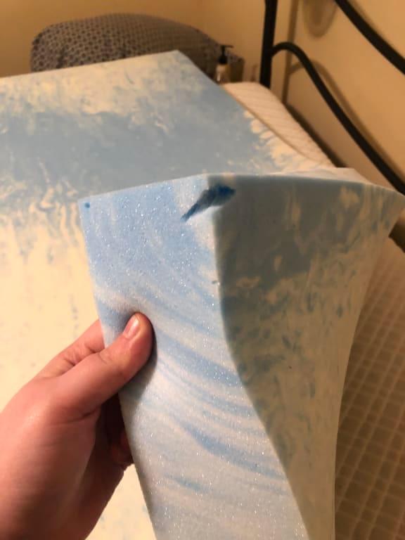 Random holes in the foam topper (the smaller holes like in the top left hand side, and below the big hole were throughout the mattress randomly.) The big hole doesn't appear to be a rip- it looks like it was made that way.