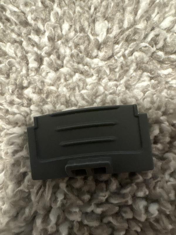 Broken tab that keeps the button in place.