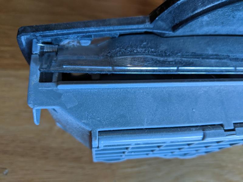 Doesn't close by itself. Prevents piece from sliding back into sweeper.