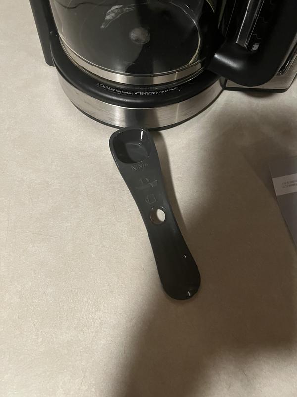 On the side has a little spoon that clicks on