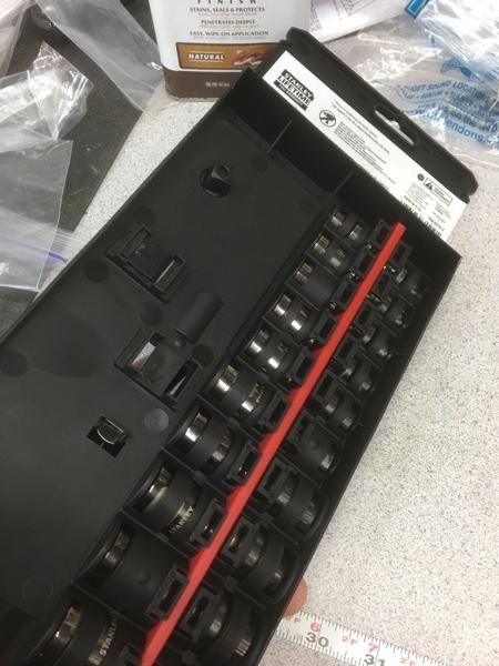 The red bar on the underside of the holder locks the sockets in place.