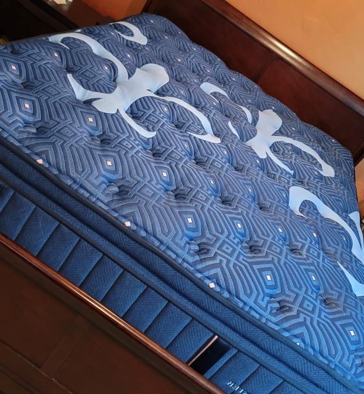 Mattress on a queen-sized frame with a box spring.