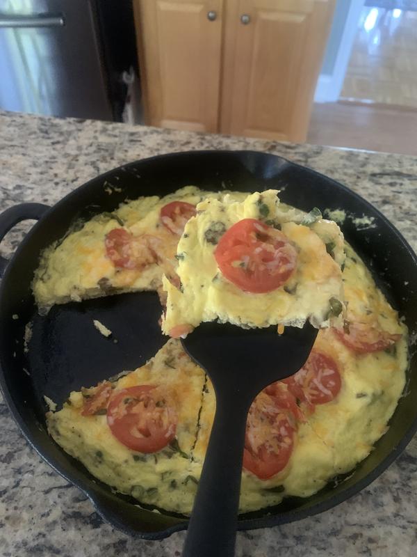 First slice of the frittata lifted out of the skillet effortlessly