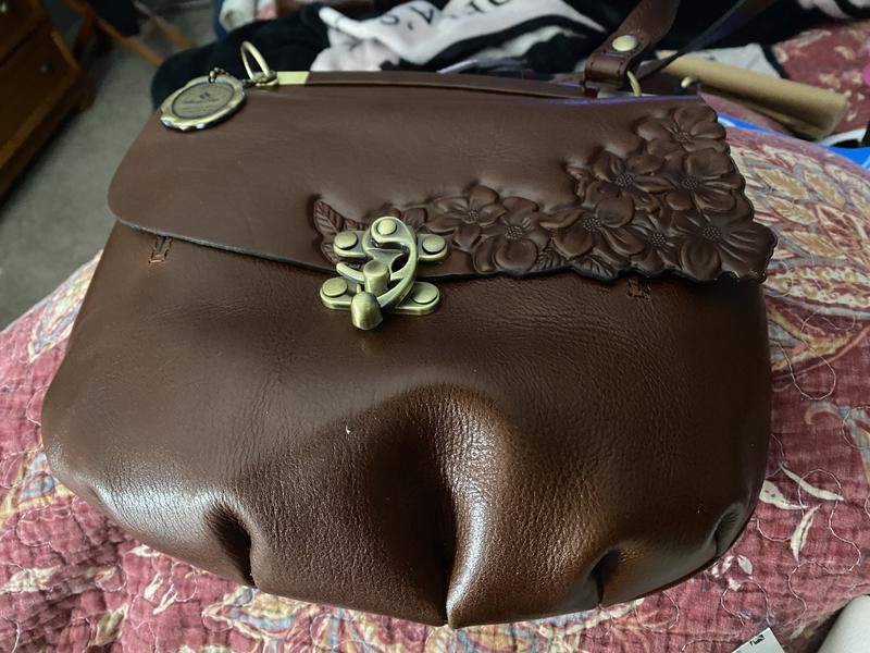 Purse has long adjustable strap.