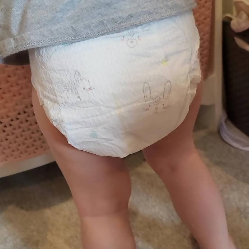Girl messing diaper.
