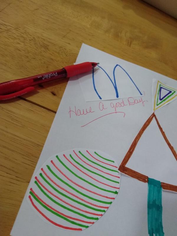 The pen with a little note written on a picture the kids made