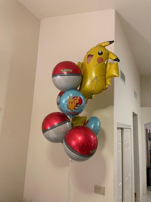 Happy Pikachu with Pokémon balls