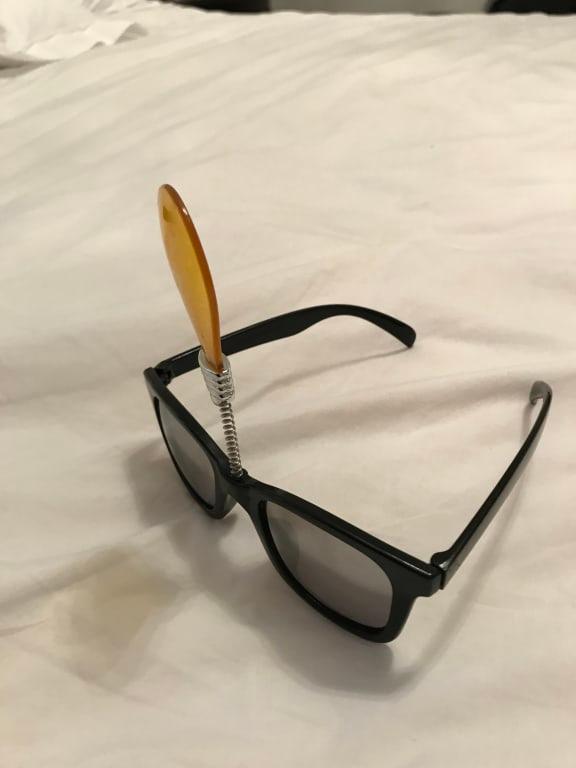 Side view of glasses with flat lightbulb on top