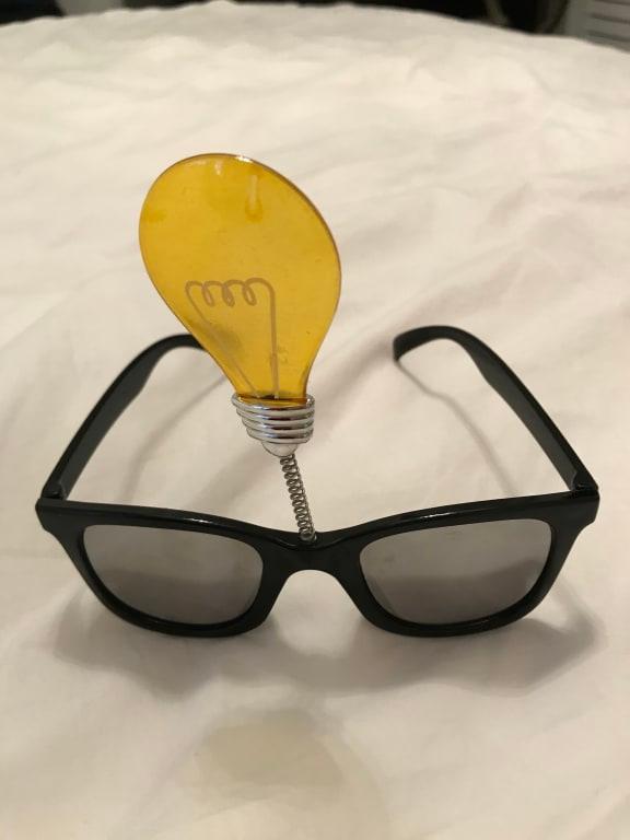 Front view of sunglasses with lightbulb on top