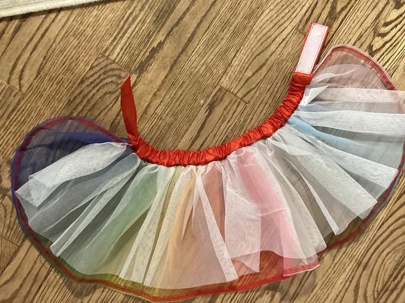 Shirt is lightweight and has A layer of white tulle behind the rainbow layer for added fullness.