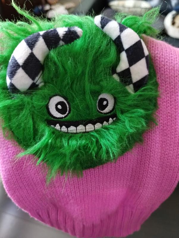 This is a well made sweater, and the fuzzy green monster has horns and a cute smile!