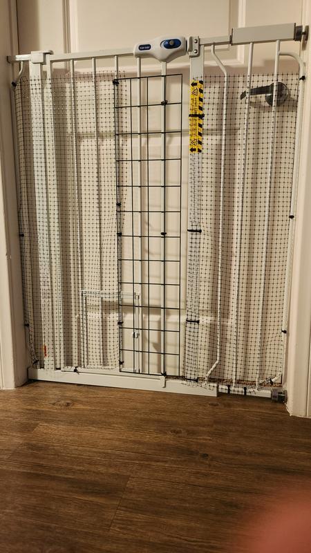 Note the nylon mesh we zipped tied to the gate to prevent cats from waltzing through and the metal grid plate we used in the middle to block while allowing the gate to still function