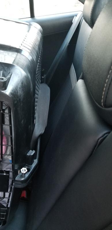 Seatbelt through tie-down slots
