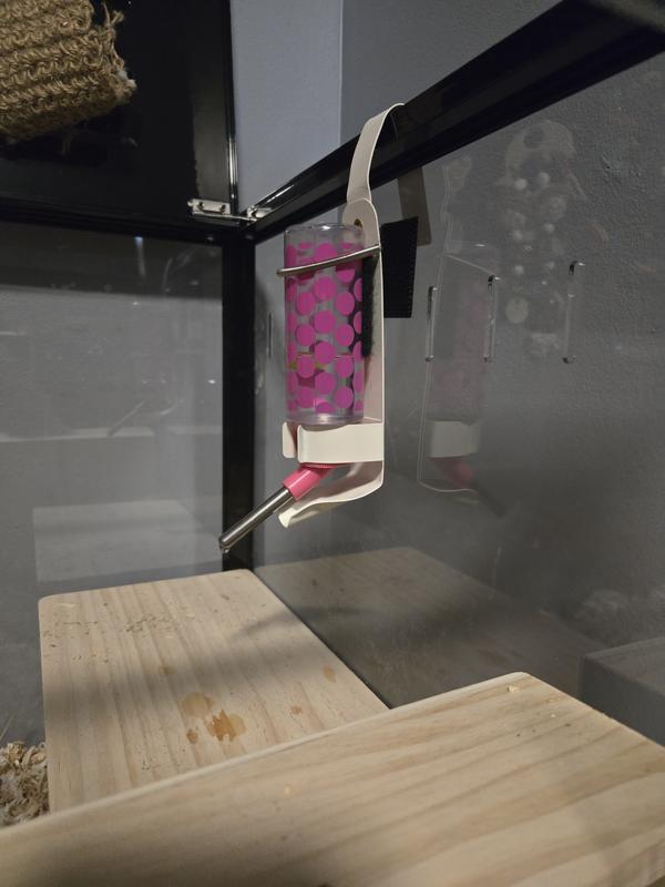 Metal bent to hook over cage.