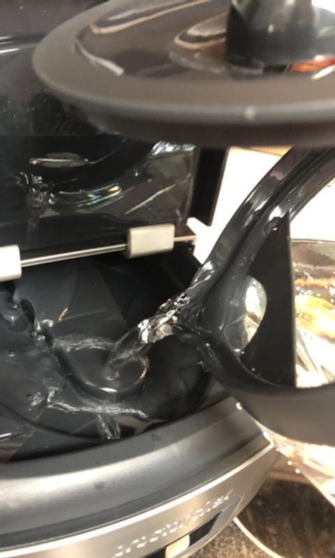 Pouring water into the top.