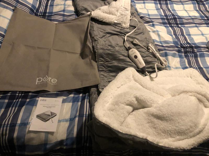 Discovering the storage bag and manual rolled up within the weighted throw blanket