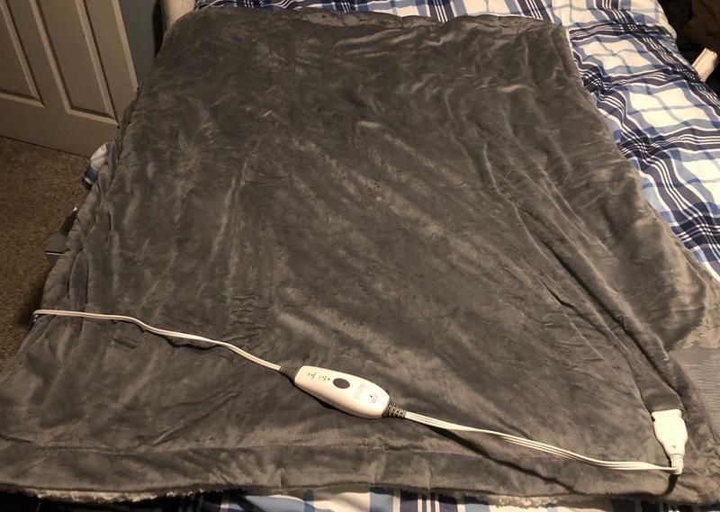 Weighted throw blanket size is 50x60 shown spread out on queen sized bed