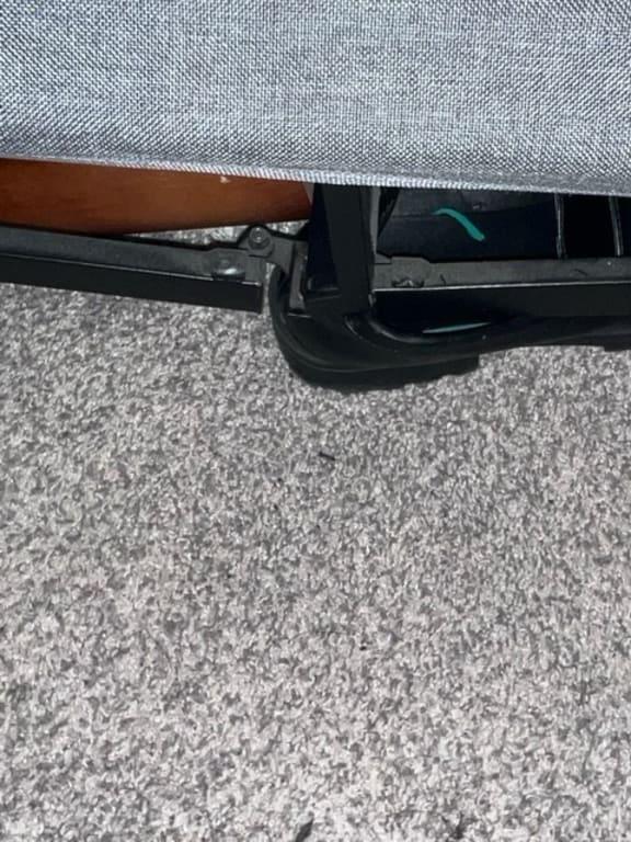 Metal frame touching the floor in the center of the bed