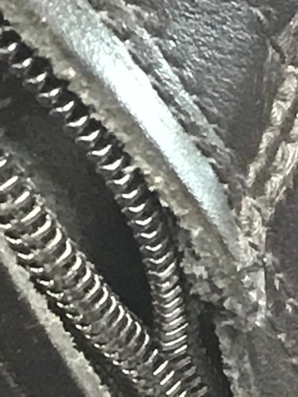 Close up of the left boot’s zipper in the up position.