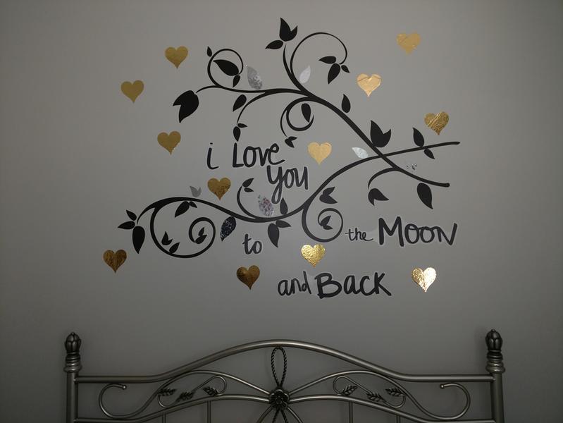 Above a queen sized bed - black branch design combined with I Love You to the Moon & Back