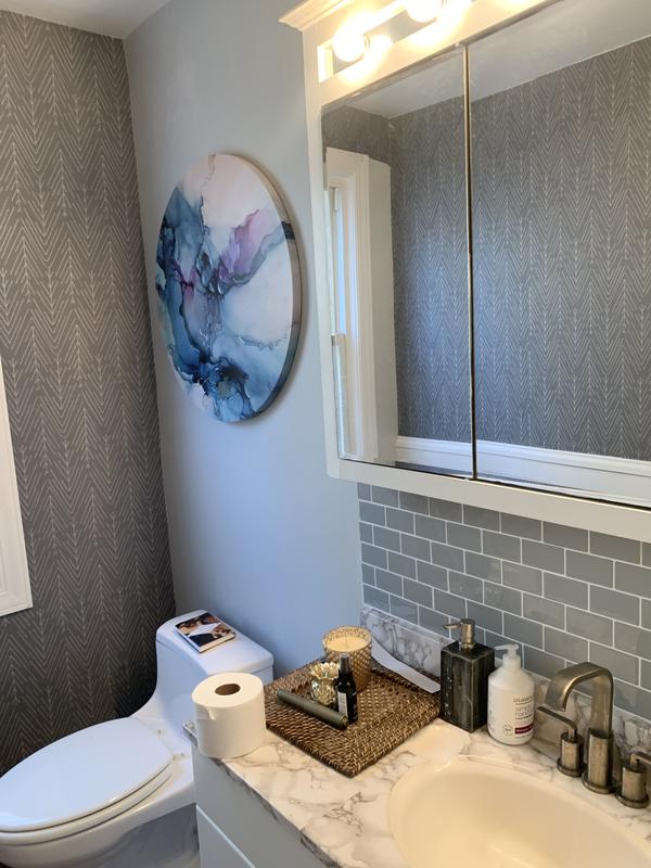 Applied the dark grey color to two walls of my powder room