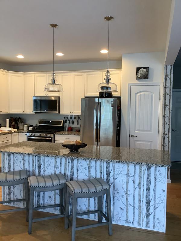 Kitchen island and slim wall next to pantry