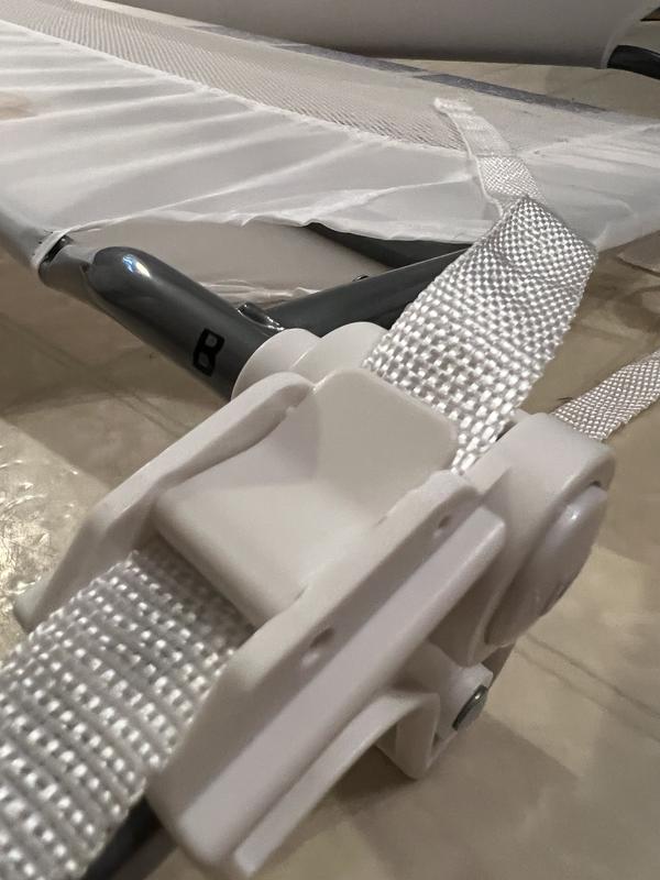 A clasp to adjust the straps under the bed.