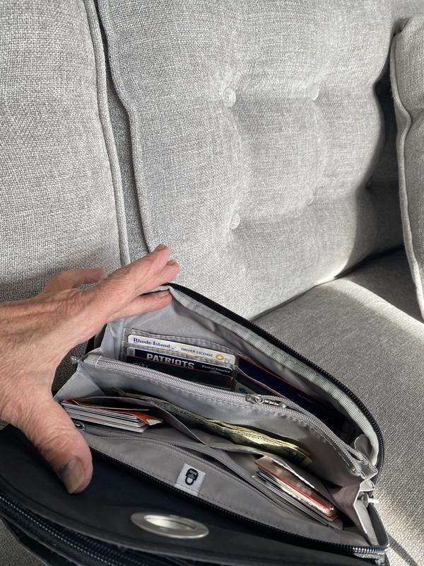 The wallet is placed on the outside for easy access. Holds bills, credit cards, checkbook and change.