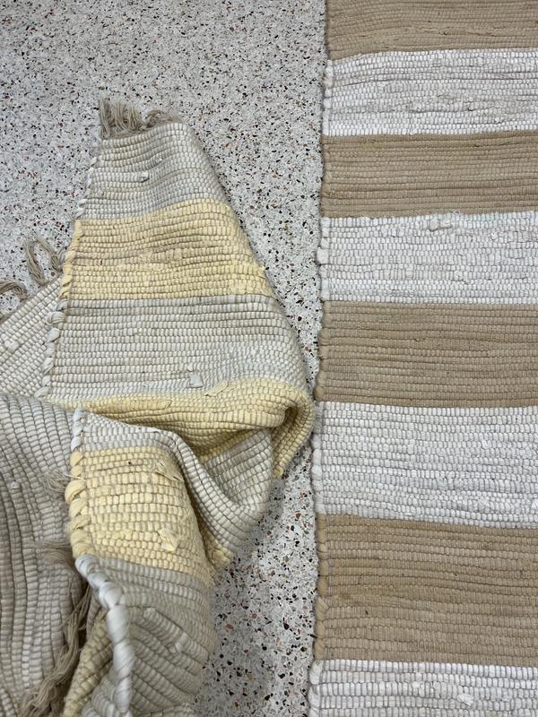 Left is washed/yellow- right is new tan/white - same rug!