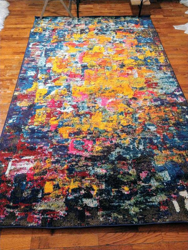 The rug on against natural wood grain floor