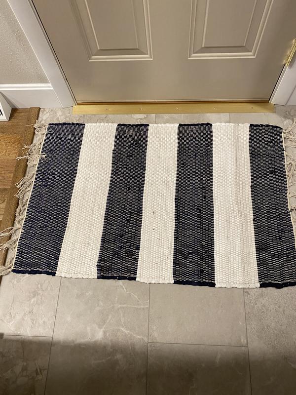 Great little rug that compliments both the wood stained floor of my kitchen and flooring in front of back door. I bought it to match the bigger rugs I purchased and the white in this has more gray, but looks great in front of the back door.