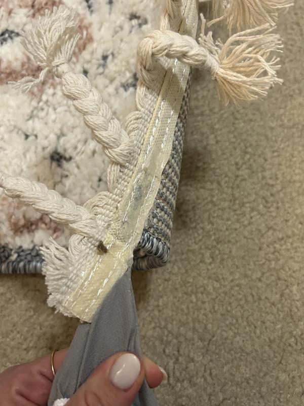 Tassels extend beyond rug with end cap/protector attached