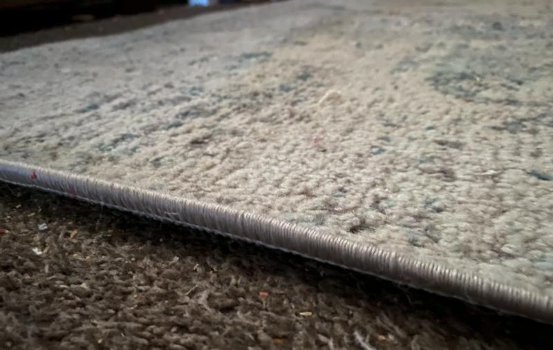 Sides of the rug do not lay flat, and are getting more curled over time.