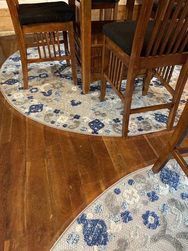 Two round rugs under table legs
