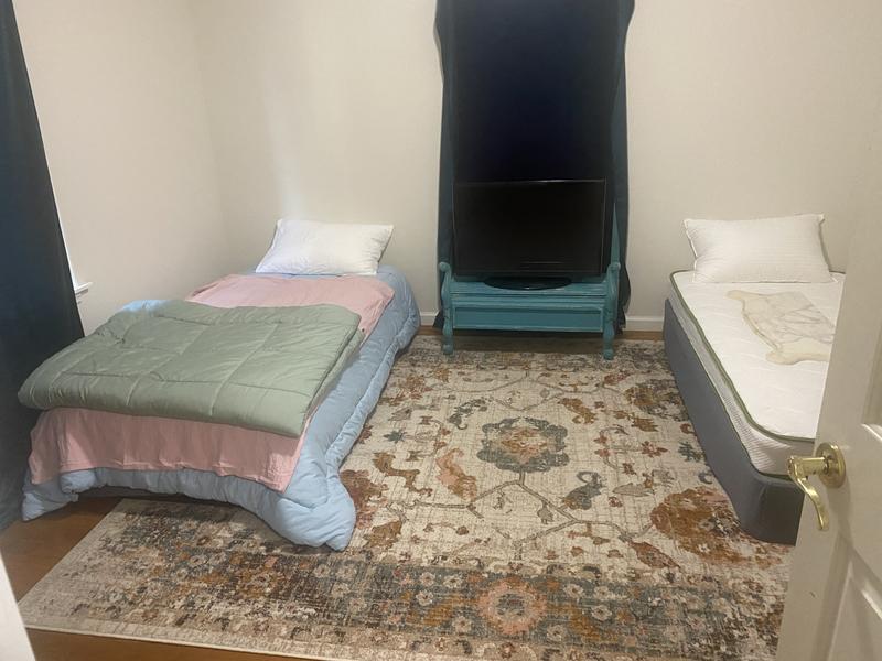 Quick Photo- zoom in to see the Pink- it matches the pink on the bed which means it might work in this room. This rug was suppose to go in my living room but not with that Pink! I’m moving into this house so excuse the lack of design