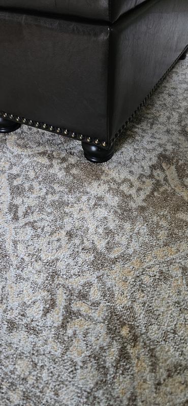 Rug looks nice under dark brown leather ottoman