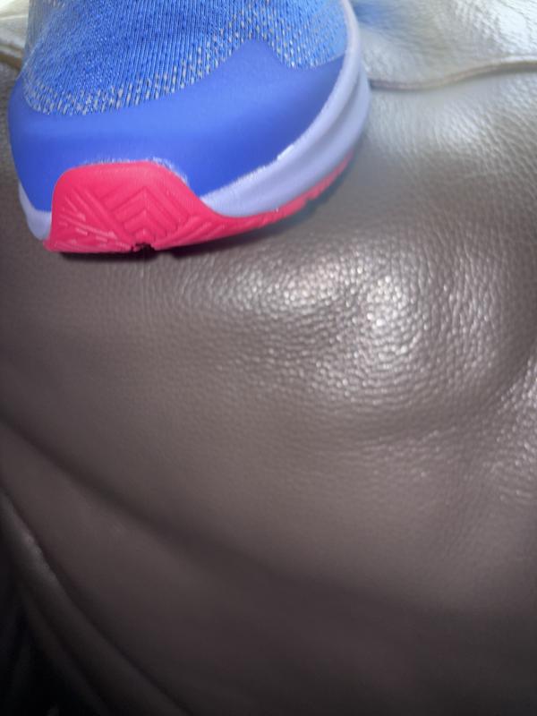 Customer photo for "Adhesive marks on sides of both sneakers"